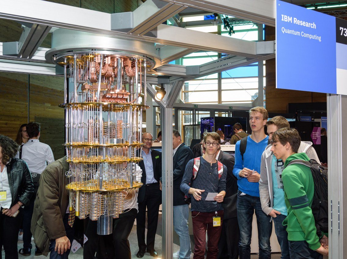 Visitors examine a model of an IBM quantum computer's chandelier wiring.