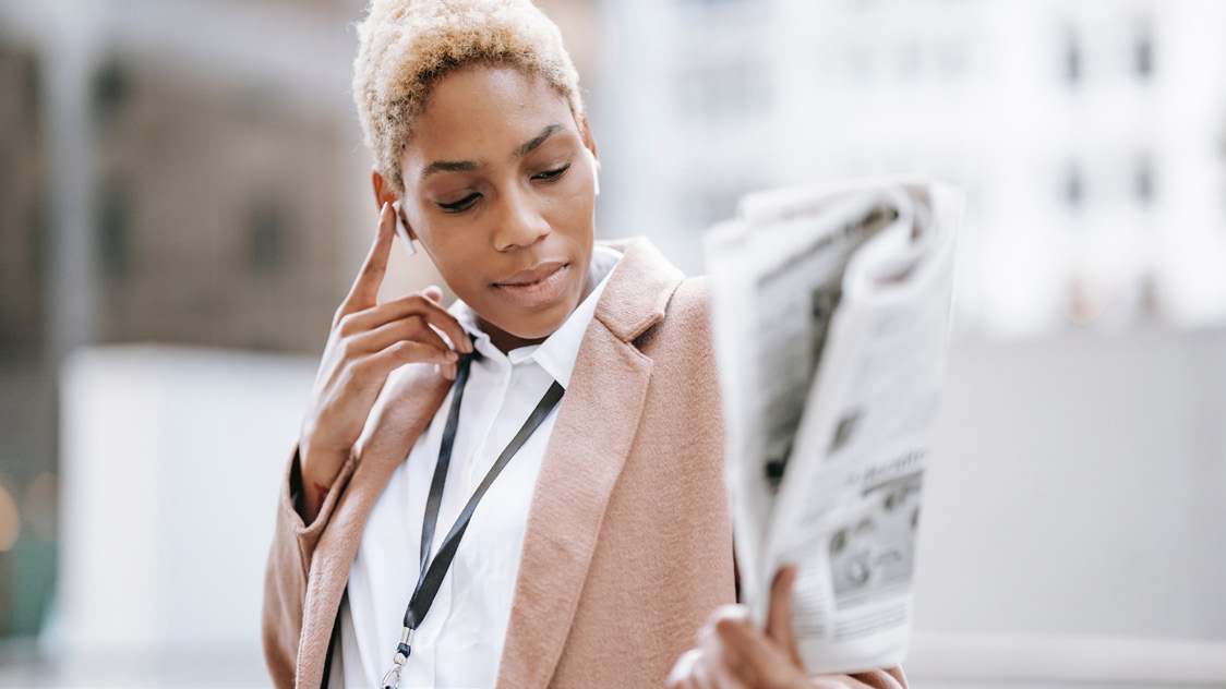 A person reading a newspaper