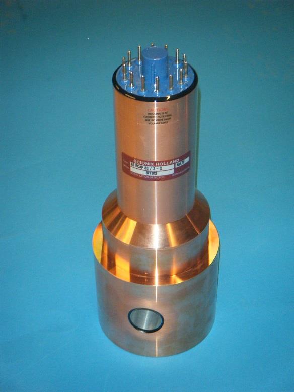 Photograph of a Scionix Holland B-style detector with copper-colored housing and a 14-pin base.