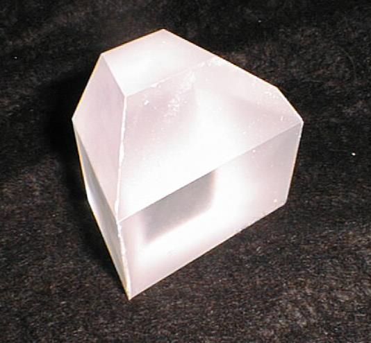 Photograph of a machined translucent scintillator crystal block with a polished readout face.