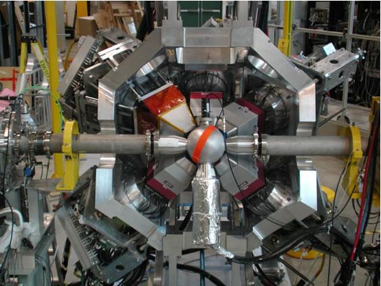 Photograph of a large multi-detector scintillator array arranged around a central beamline chamber.