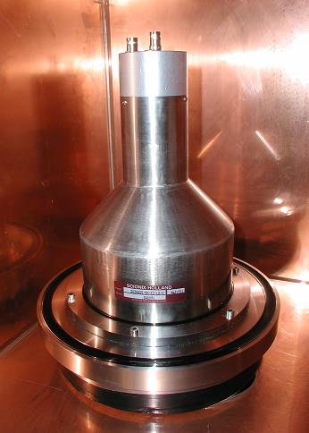 Photograph of a large custom Scionix Holland detector with a tapered stainless head on a wide disc base.