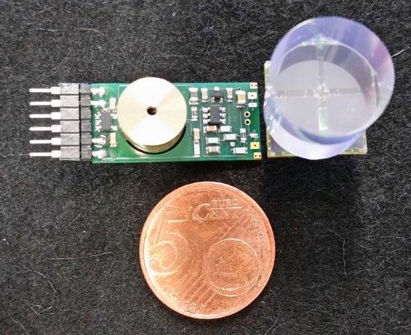 Bias generator and preamplifier module shown next to a coin for scale