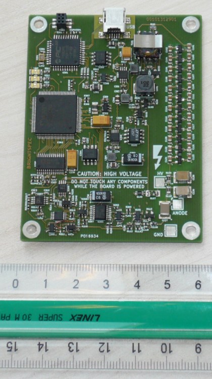 TOPAZ-Pico bare printed-circuit board with USB, HV, anode, and ground connections, shown against a ruler for scale